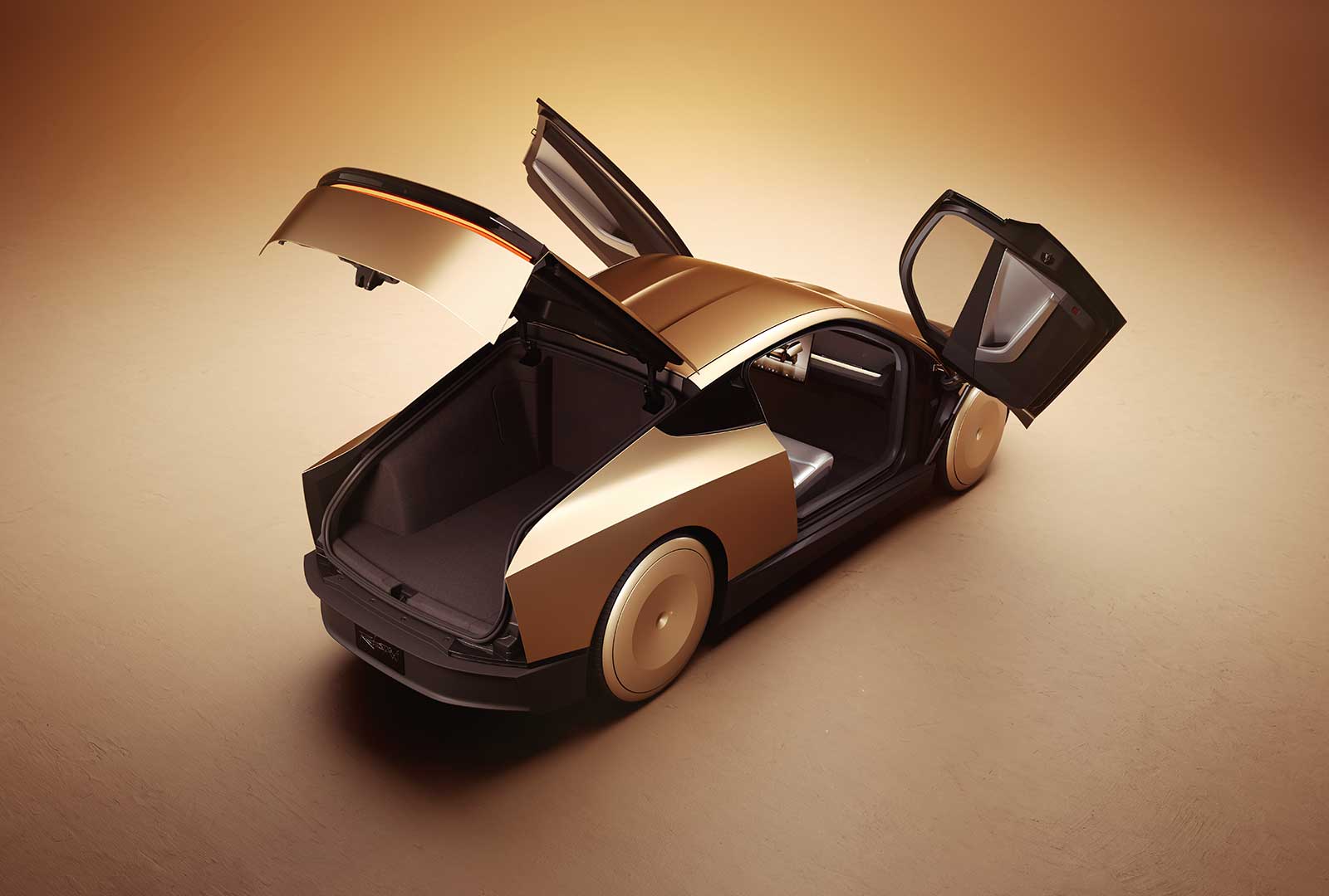 Top view of the Cybercab with butterfly doors and trunk open, showing the deep rear cargo area
